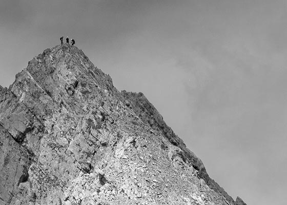 La silueta de tres montañeros en la cumbre de uno de los Picos del Portillín da una nueva dimensión de la montaña.